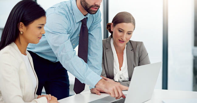 people looking at a computer