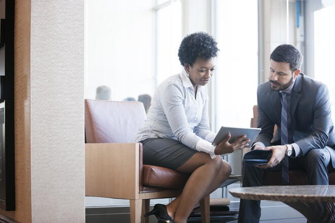 man and woman looking at a tablet