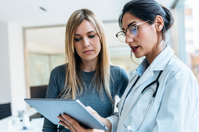 healthcare worker looking at a tablet