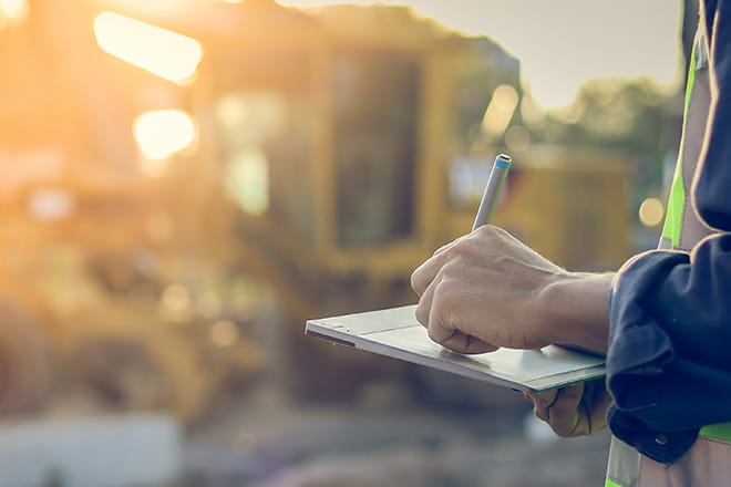 Person writing on a notepad