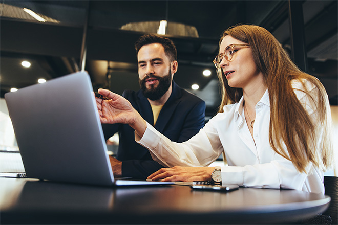 Two people looking at a computer screen