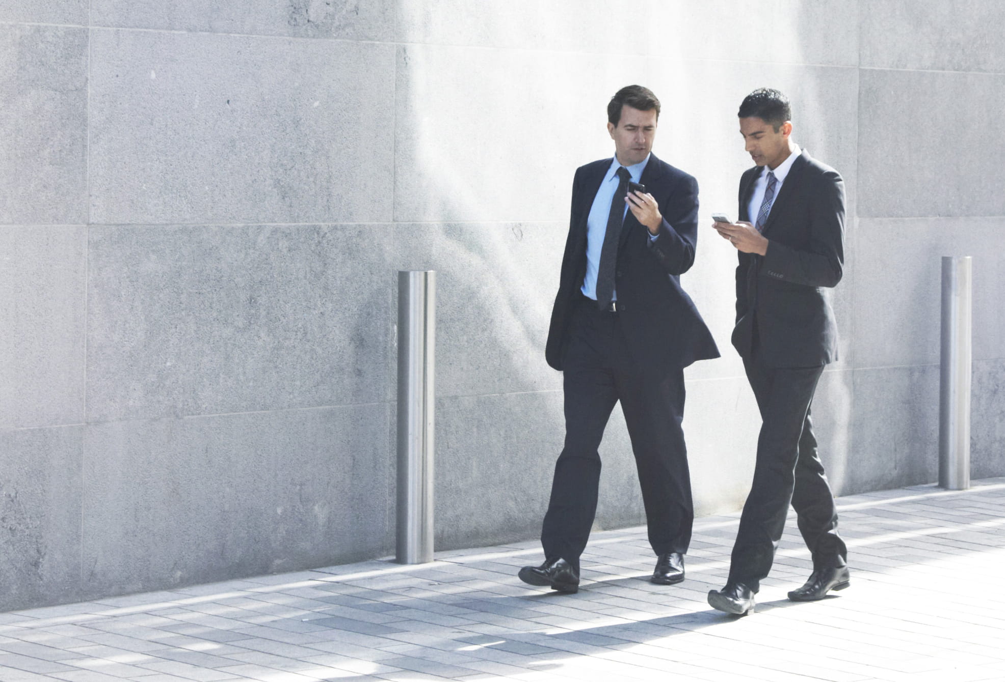 Three people in business attire talking in an office