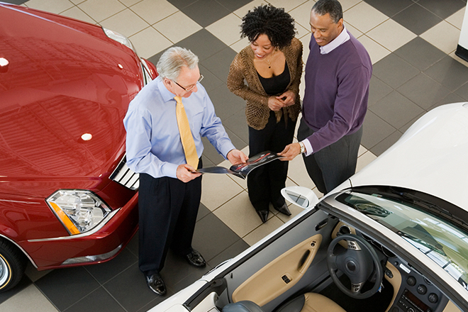 People buying a car at a dealership