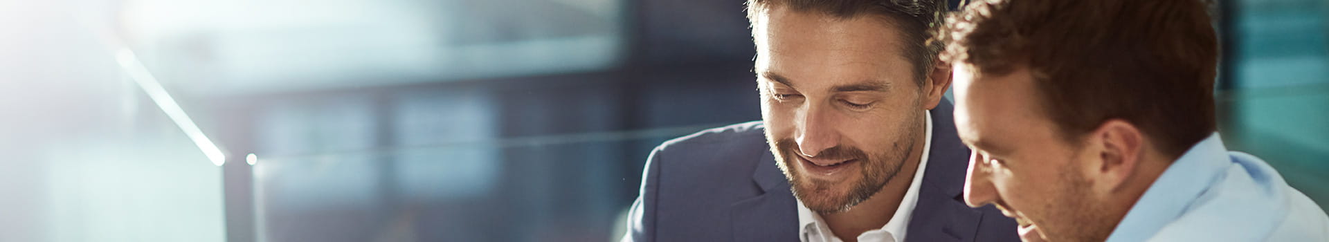 Two coworkers looking over a file