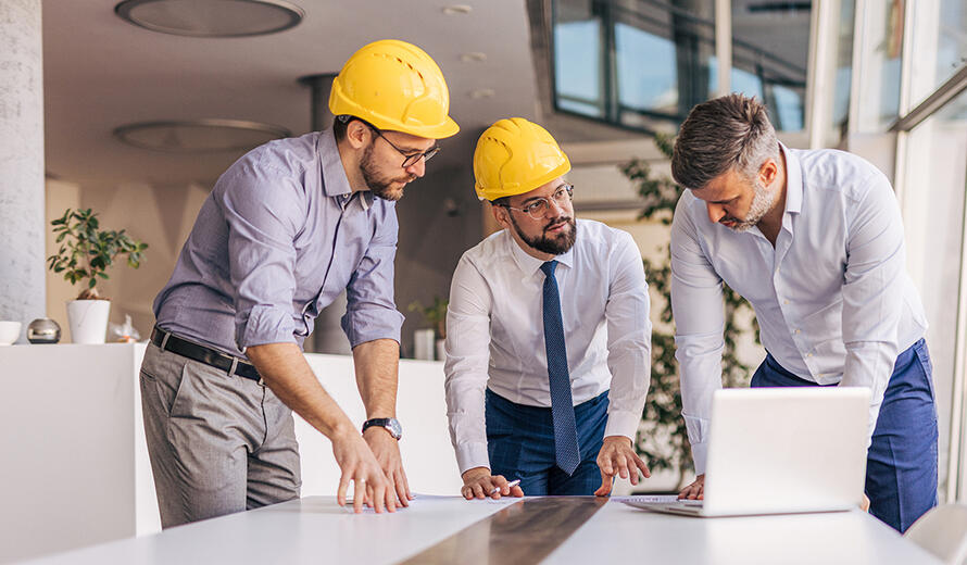 construction workers talking around a table