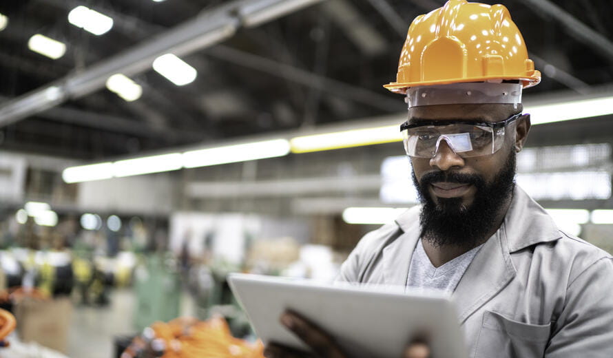 Man working with his digital tablet in the factory