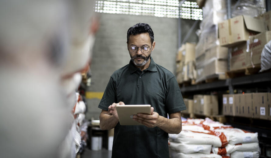 Manager using his tablet working in industry