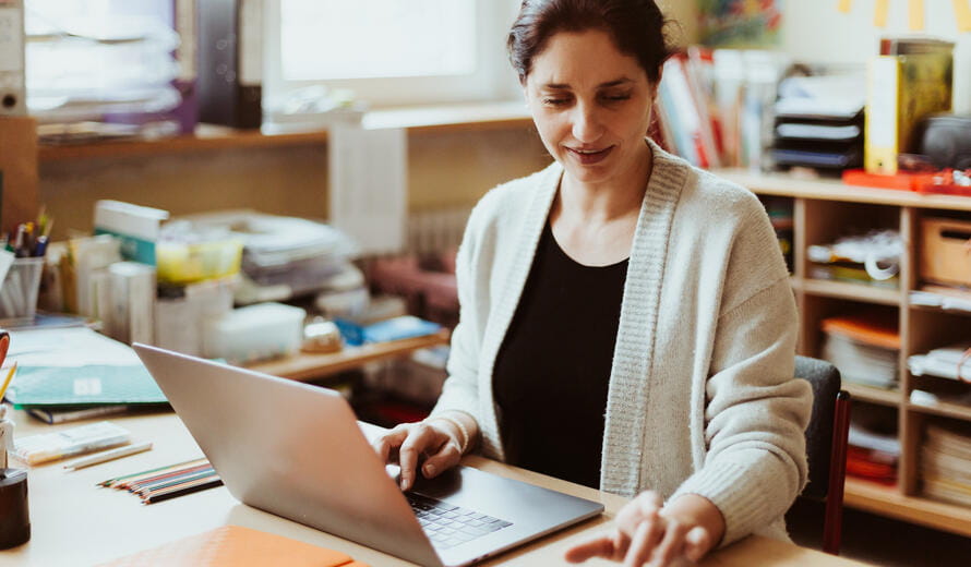 Stock photography image showing a person working at a desk.