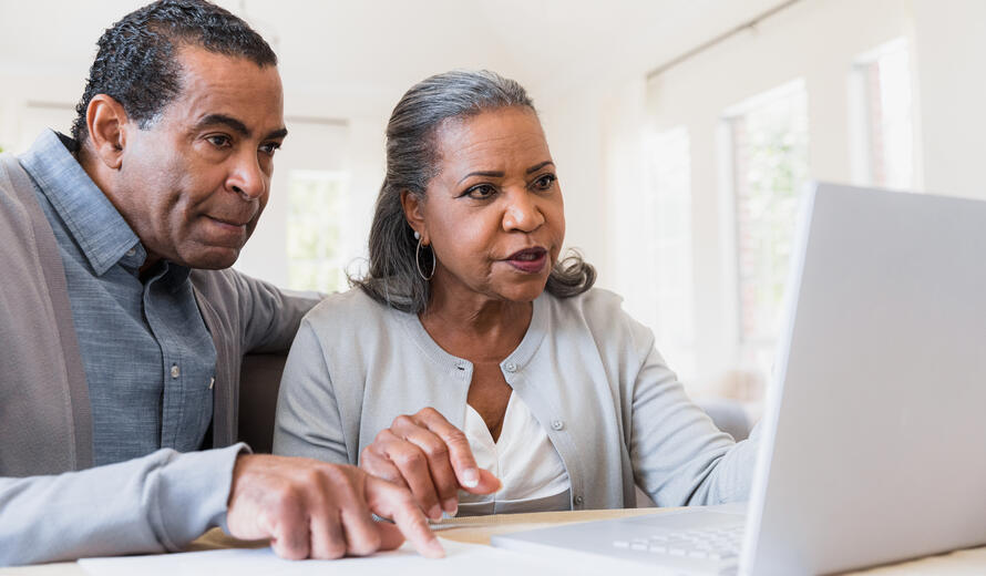 The couple sits together at the computer to review an email they received.