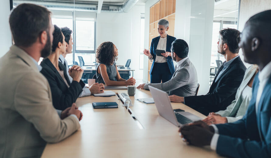 Multiethnic group of businesspeople sitting together and having a meeting in the office.