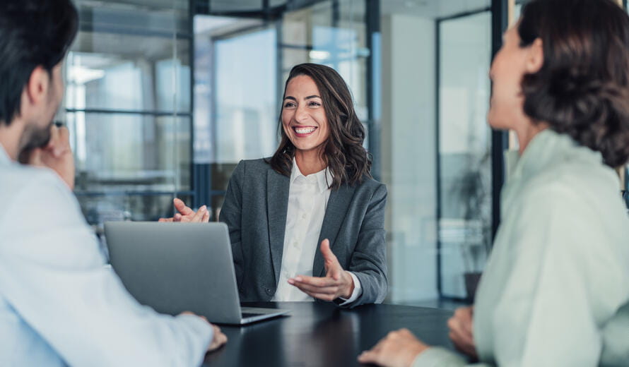 Shot of group of business persons in business meeting. Three entrepreneurs on meeting in board room. Corporate business team on meeting in modern office. Female manager discussing new project with her colleagues. Company owner on a meeting with two of her employees in her office.
