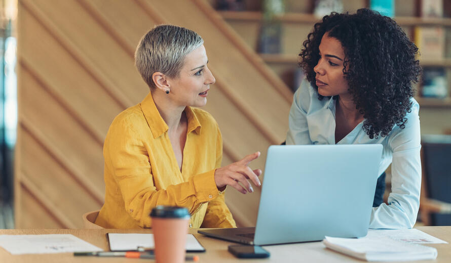 Two businesswomen talking in the office