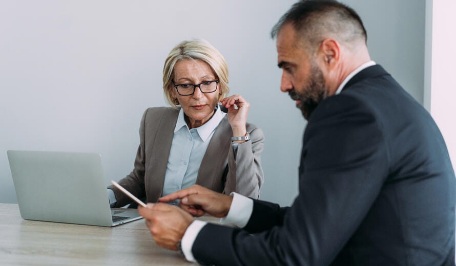 Two business professionals collaborating in an office environment.