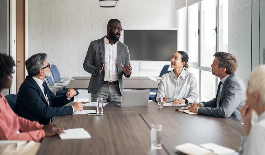 Businessman presenting strategy to a diverse team.