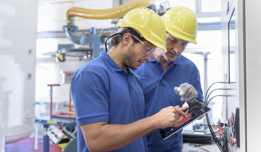 workers looking at a tablet