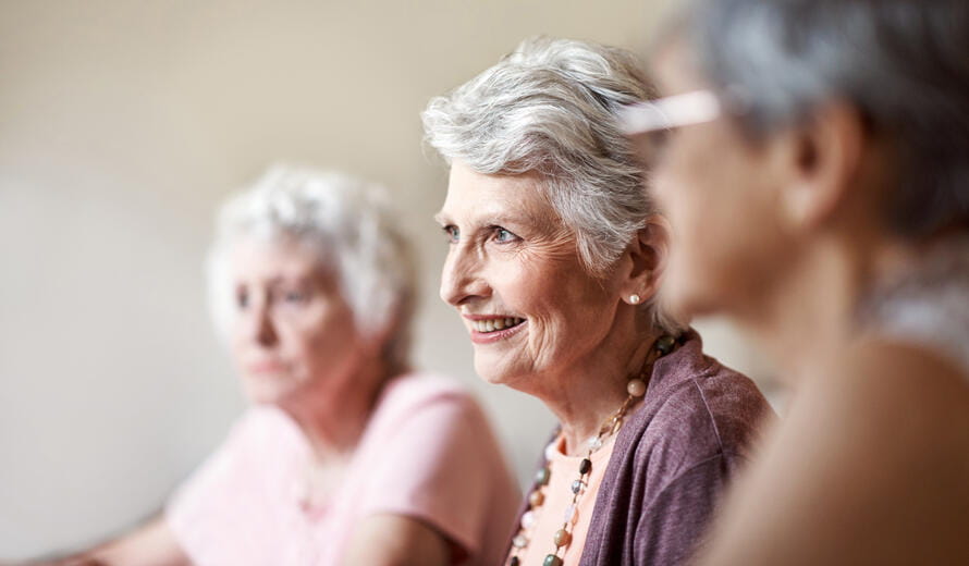 Shot of a group of seniors playing a board game in their retirement home.