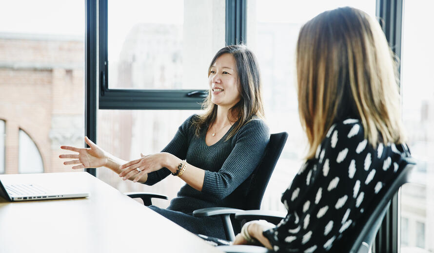 Businesswoman leading discussion during meeting in office conference room