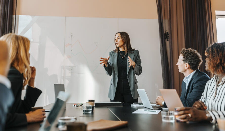 Person presenting at a conference table meeting