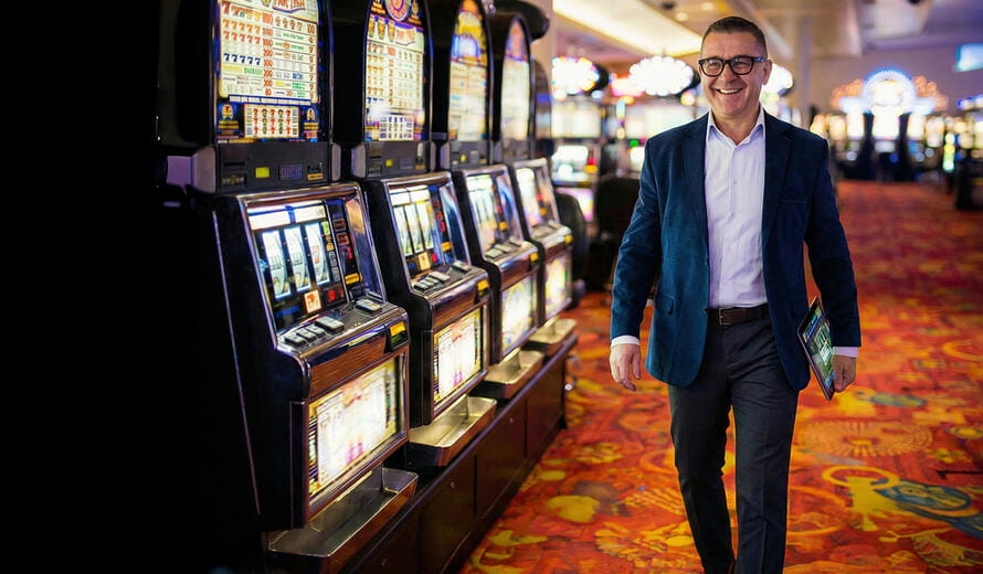 Professional stock-style image depicting a casino floor environment with gaming machines and a managerial figure, suitable for Tribal Gaming-related marketing or creative use.