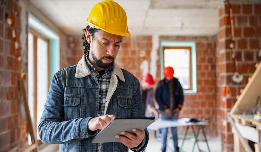 a construction worker on a tablet