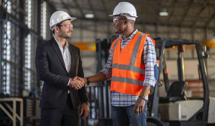 Multi-ethnic workers talking in metal fabrication plant