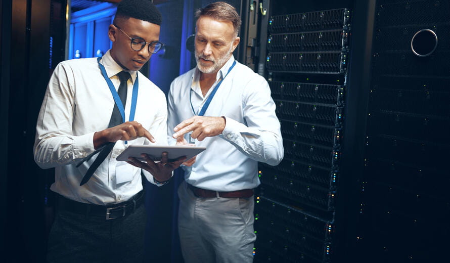 a few men looking at a tablet