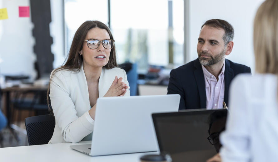 a man and a woman looking at a laptop