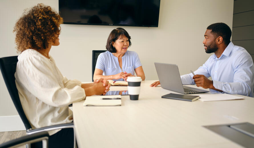A diverse group of business professionals working together in a meeting.