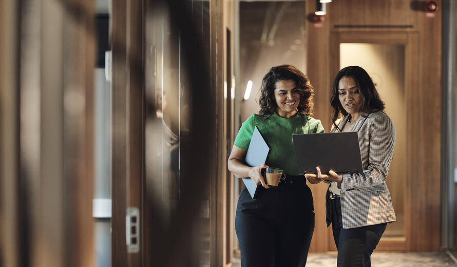 two women looking at a computer