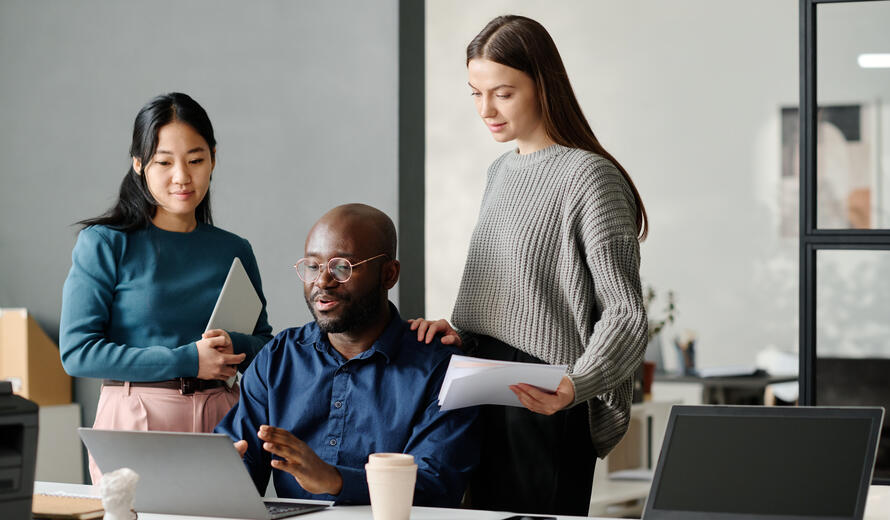 a few business people looking at a computer