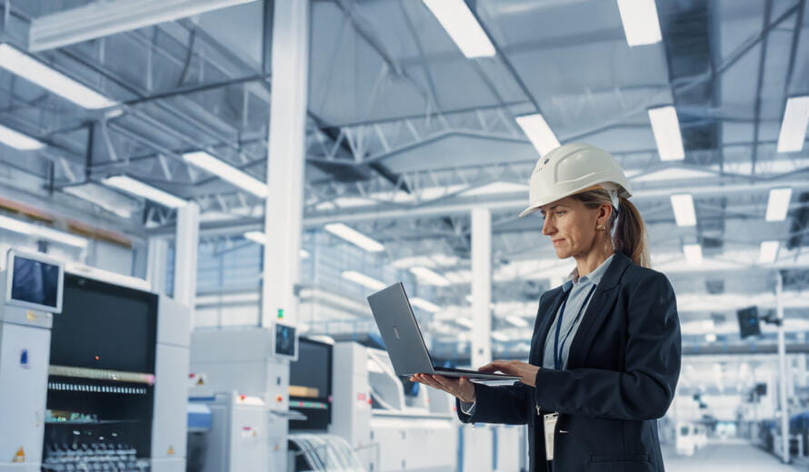 woman in a hard hat on a laptop