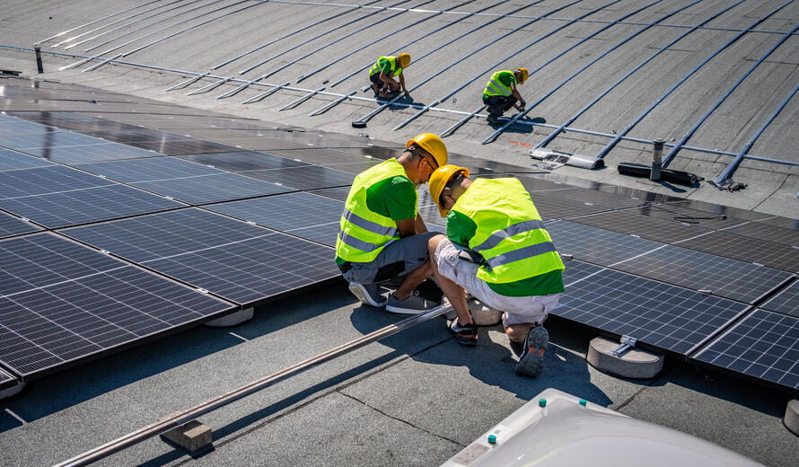 construction workers on a solar panel