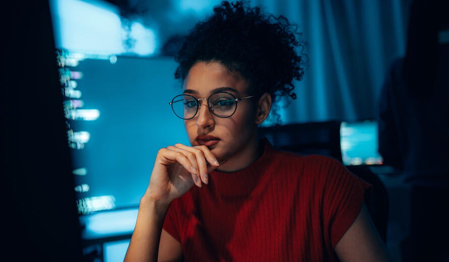 Young Hispanic woman in technology career, authentic portrait of programmer or cybersecurity professional