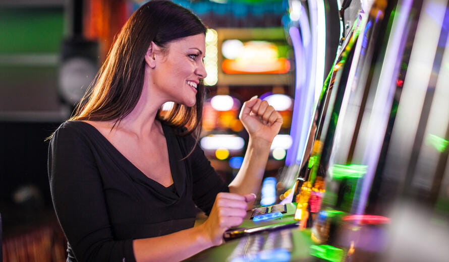 Young woman playing slot machines at the Casino