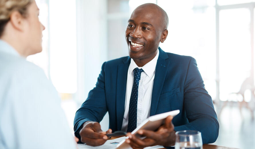 Shot of a young businessman and businesswoman having a discussion in a modern office