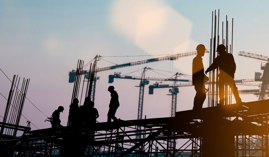 Silhouette of engineer and construction team working at site over blurred background sunset