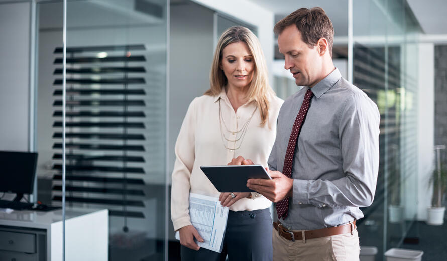 two people looking at a tablet