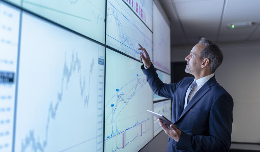 man in a suit looking at data