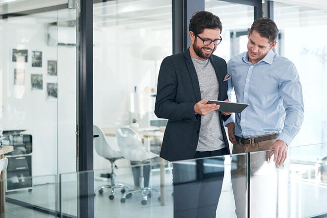 men looking at a tablet