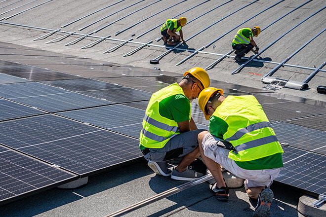 workers laying solar panels