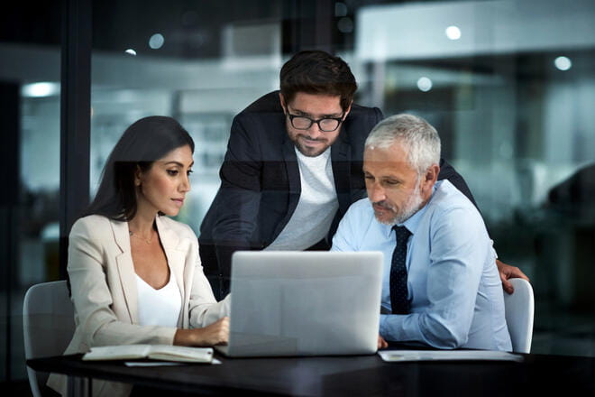 3 people looking at a computer