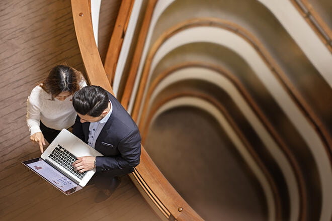 man and woman looking at a laptop